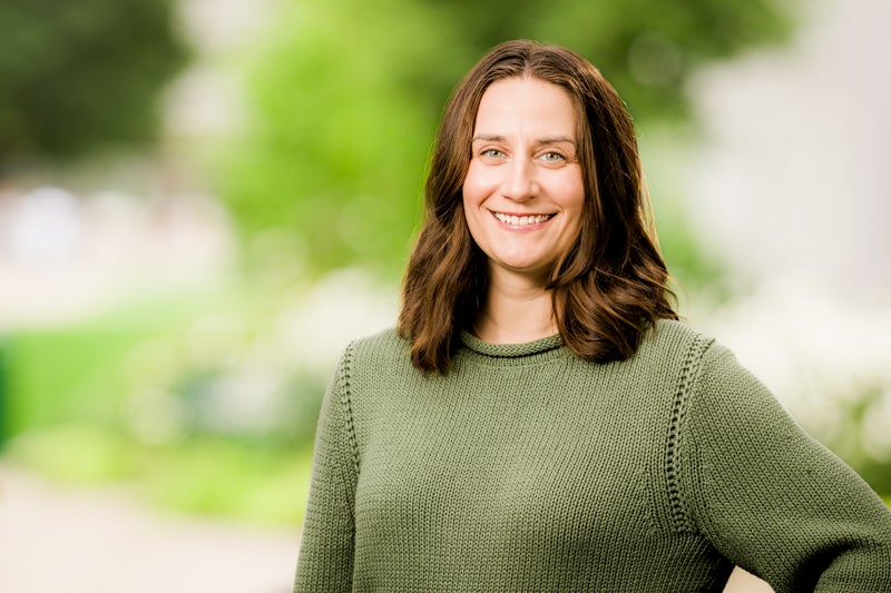 Alexis Drakatos wearing a sage green sweater